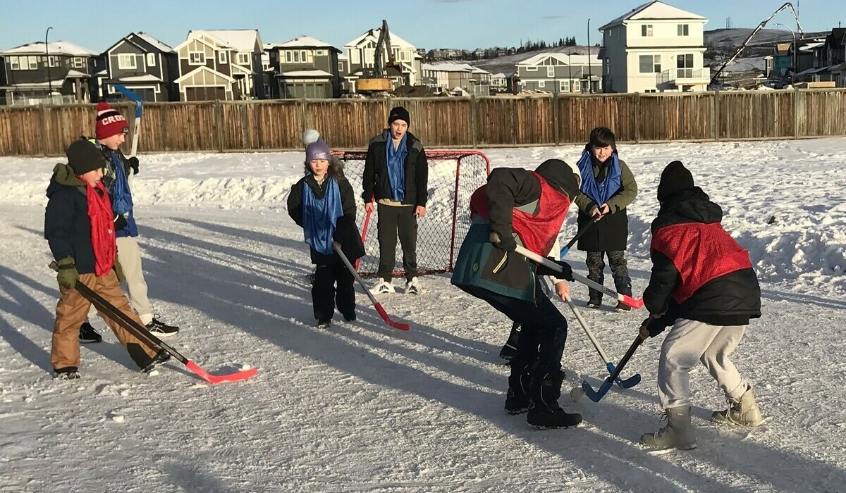 A group of students playing outdoor hockey